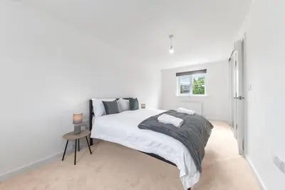 a white bedroom with a bed and a window at Barrow- 4 bedroom Detached House in Roose