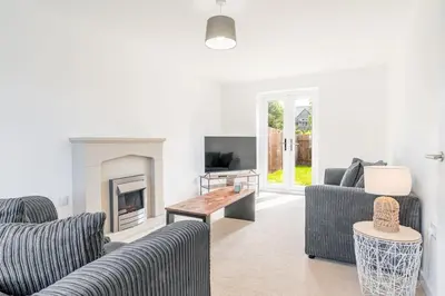 a living room with two couches and a fireplace at Barrow- 4 bedroom Detached House in Roose