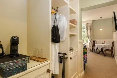 a room with a closet with a shirt hanging on the wall at Grange Manor in Grange Over Sands