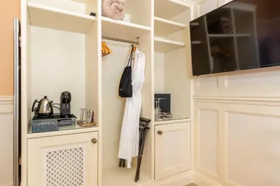a kitchen with white cabinets and a microwave at Grange Manor in Grange Over Sands
