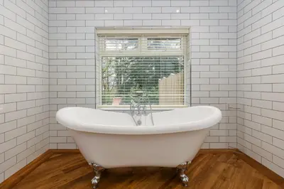 a white bath tub in a bathroom with a window at Grange Manor in Grange Over Sands