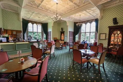 a restaurant with tables and chairs and a bar at Ashton Hall at Lancaster Golf Club in Lancaster