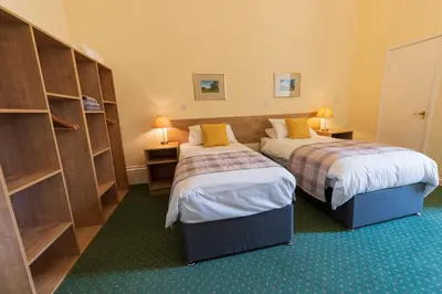 a hotel room with two beds and two lamps at Ashton Hall at Lancaster Golf Club in Lancaster