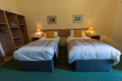 a hotel room with two beds and two lamps at Ashton Hall at Lancaster Golf Club in Lancaster