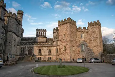 an old castle with cars parked in front of it at Ashton Hall at Lancaster Golf Club in Lancaster