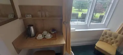 a room with a table and a chair and a window at Ashton Hall at Lancaster Golf Club in Lancaster