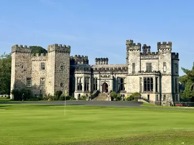 an old castle with a green lawn in front of it at Ashton Hall at Lancaster Golf Club in Lancaster