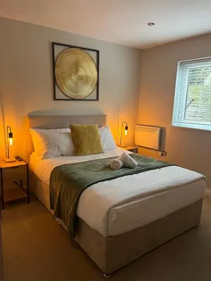 a bedroom with a large bed and a window at The Slipway Cabins with Hottub in Burscough