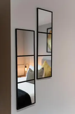 two mirrors on a wall in a room at The Slipway Cabins with Hottub in Burscough