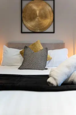 a bed with two pillows on top of it at The Slipway Cabins with Hottub in Burscough