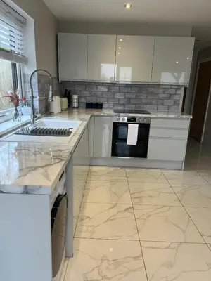 a kitchen with a sink and a stove top oven at The Slipway Cabins with Hottub in Burscough