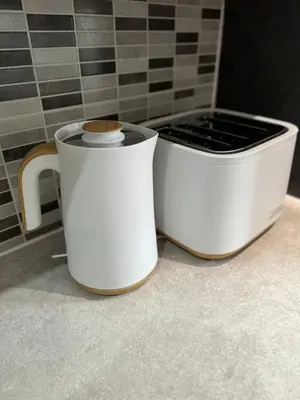 two white crockpots sitting on a counter in a bathroom at 2 Bed Apartment Scarisbrick Street Ormskirk - Rooms by Vici in Ormskirk
