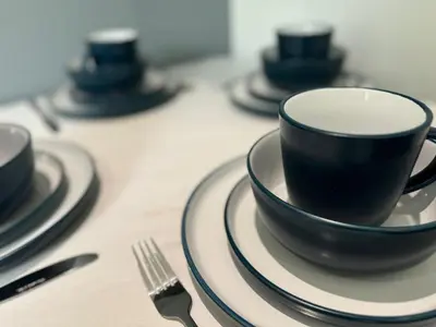a group of black cups and plates on a table at 2 Bed Apartment Scarisbrick Street Ormskirk - Rooms by Vici in Ormskirk