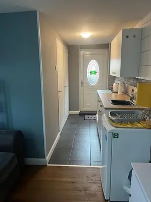 a kitchen with a sink and a counter top at Birkdale's Hidden Gem in Southport