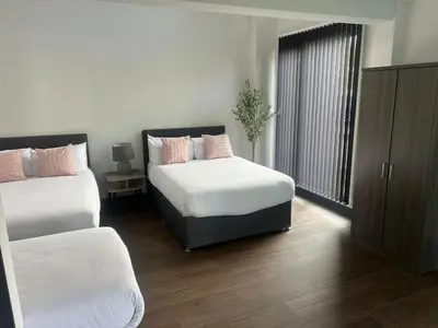 a bedroom with two beds and a window at Dockside Aparthotel, Best Western Signature Collection in Liverpool