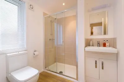 a bathroom with a shower and a toilet and a sink at Driftwood Lodge - South Lakeland Leisure Village in Carnforth