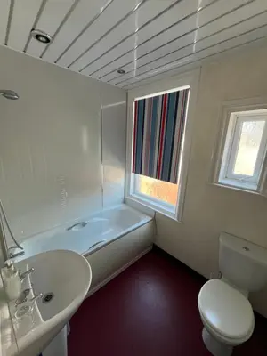 a bathroom with a sink and a tub and a toilet at Marston town centre villa in Blackpool
