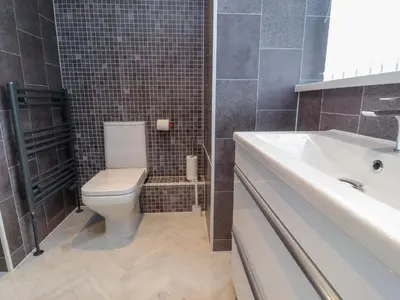 a bathroom with a white toilet and a sink at Flat 1, Sandridge Court in Knott End-on-Sea
