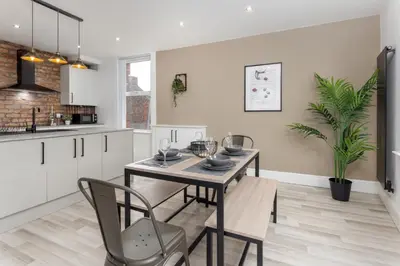 a kitchen and dining room with a table and chairs at The Wavertree Rooms - Air Host & Stay - 6 Bedrooms in Liverpool