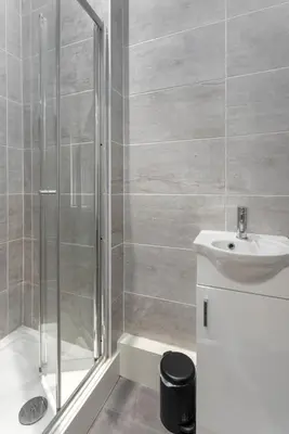 a bathroom with a shower and a sink at The Wavertree Rooms - Air Host & Stay - 6 Bedrooms in Liverpool