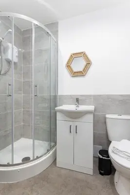 a bathroom with a shower and a sink and a toilet at The Wavertree Rooms - Air Host & Stay - 6 Bedrooms in Liverpool