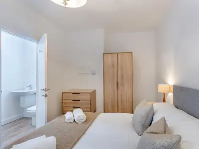 a bedroom with a bed with two white towels on it at Uk46866 - Hawkshead in Ulverston