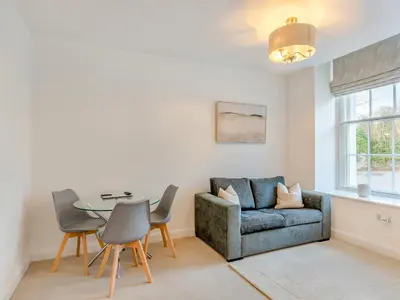 a living room with a couch and a table and chairs at Uk46866 - Hawkshead in Ulverston