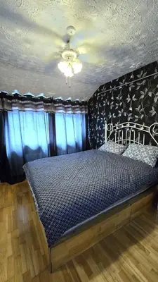 a bedroom with a bed and a ceiling at Ritchie Guest House in Wigan