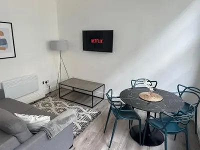 a living room with a table and a couch at Harrington Street Apartments Liverpool by Beehosting in Liverpool