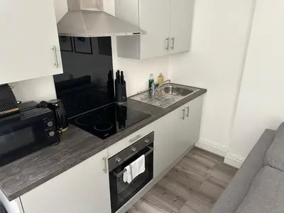 a kitchen with a sink and a stove top oven at Harrington Street Apartments Liverpool by Beehosting in Liverpool