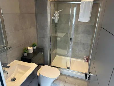 a bathroom with a shower and a toilet and a sink at Harrington Street Apartments Liverpool by Beehosting in Liverpool
