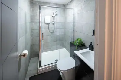 a bathroom with a shower and a toilet and a sink at Harrington Street Apartments Liverpool by Beehosting in Liverpool