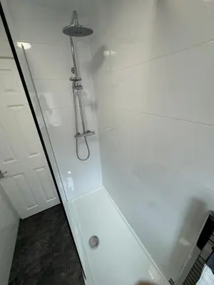 a bathroom with a shower with a glass door at Theo apartment 150 meters from the winter gardens large groups welcome in Blackpool