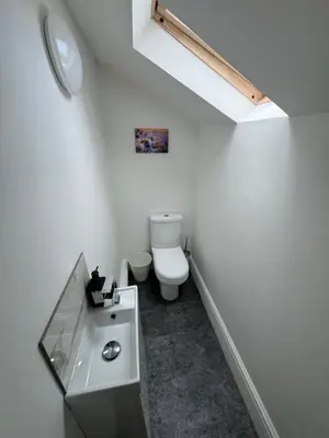 a white bathroom with a toilet and a sink at Theo apartment 150 meters from the winter gardens large groups welcome in Blackpool