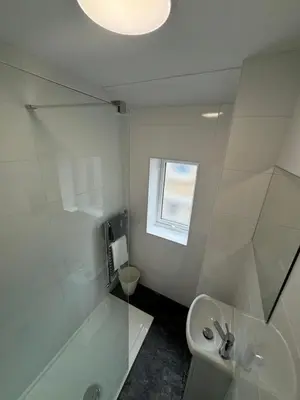 a bathroom with a sink and a toilet and a window at Theo apartment 150 meters from the winter gardens large groups welcome in Blackpool