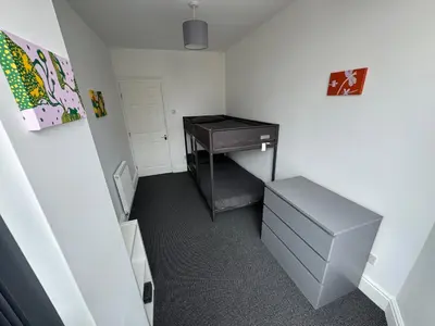 a small room with a sink and a desk at Theo apartment 150 meters from the winter gardens large groups welcome in Blackpool
