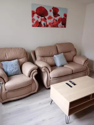 a living room with a couch and a coffee table at Mesnes Place in Wigan