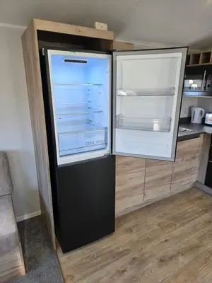 an empty refrigerator with its door open in a kitchen at 8 Berth Caravan Haven Marton Mere in Blackpool