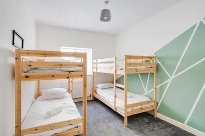 a room with two bunk beds in a room at Huge Apartment - 8 Beds - Free Parking - Long Stays! in Liverpool