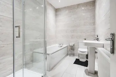 a bathroom with a tub and a sink and a shower at Huge Apartment - 8 Beds - Free Parking - Long Stays! in Liverpool