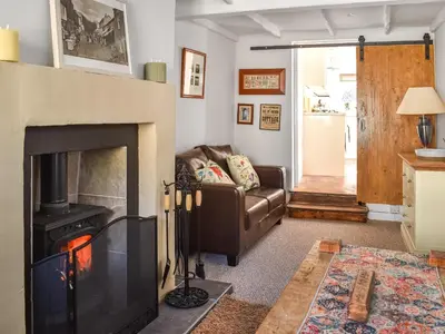 a living room with a couch and a fireplace at Seagull Cottage in Heysham