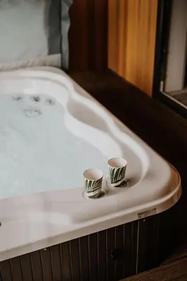 two cups sitting on top of a bath tub at Nash - Bowland Retreat Lodges Clitheroe, Ribble Valley, Lancashire in Clitheroe