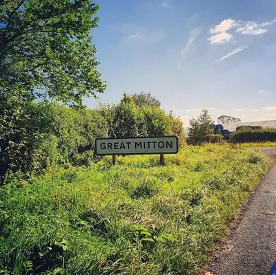 a street sign in the grass next to a road at Nash - Bowland Retreat Lodges Clitheroe, Ribble Valley, Lancashire in Clitheroe