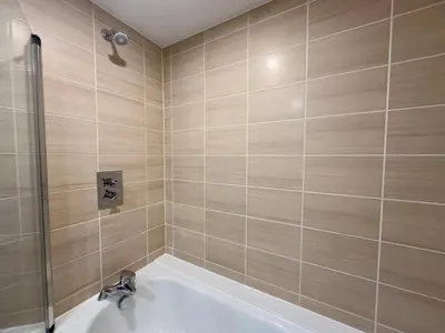 a bathroom with a bath tub and a sink at Monarchs Quay Arena Apartments by Happy Days in Liverpool