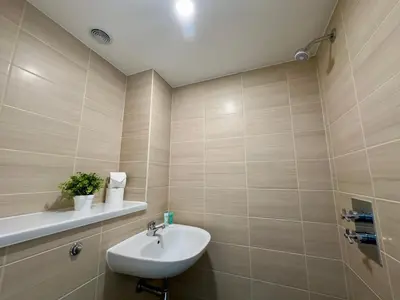 a bathroom with a sink and a toilet in it at Monarchs Quay Arena Apartments by Happy Days in Liverpool