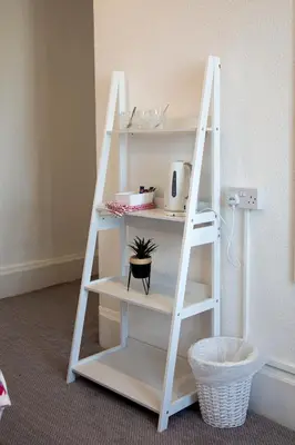 a ladder leaning against a wall with a shelf at The Highlands, Bispham in Blackpool
