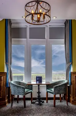 a room with a table and two chairs and a window at The Highlands, Bispham in Blackpool