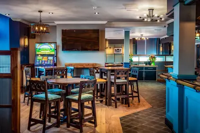 a kitchen with wooden tables and chairs in a room at The Highlands, Bispham in Blackpool