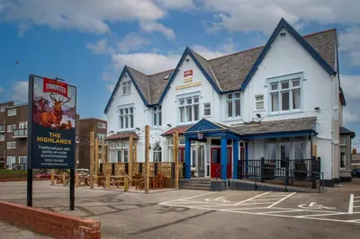 a white building with a sign in front of it at The Highlands, Bispham in Blackpool