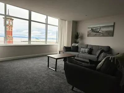 a living room with a couch and a table and a clock tower at Clock Tower Apartments 1 in Morecambe
